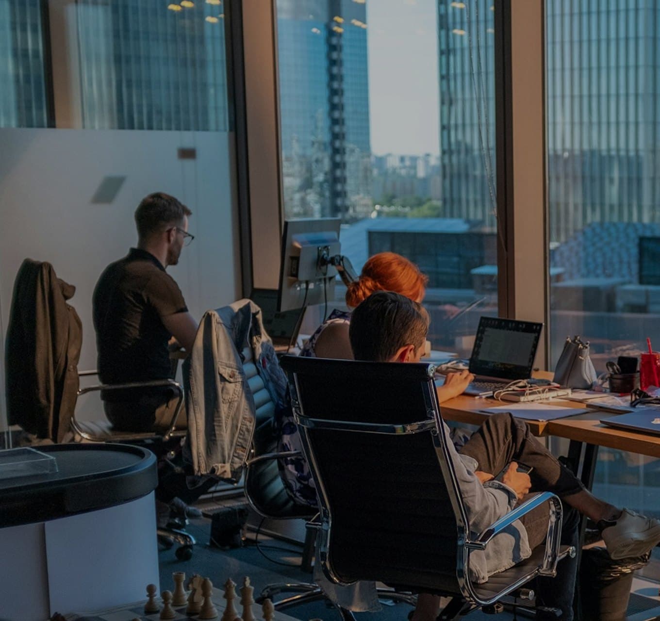Cognivise engineers working at their desks in an office overlooking the city